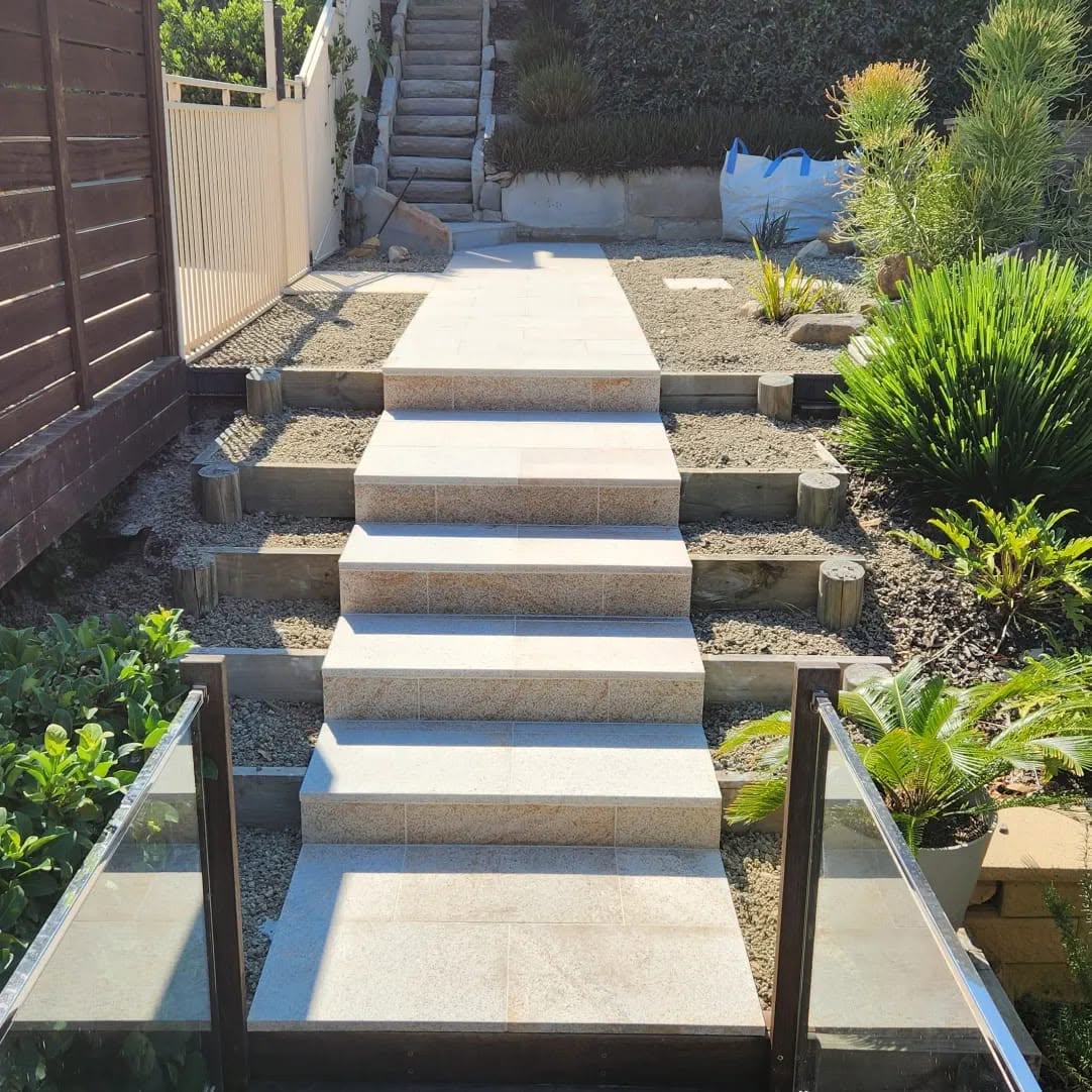 Fibonacci-built paved steps and terraced garden beds on a sloped site