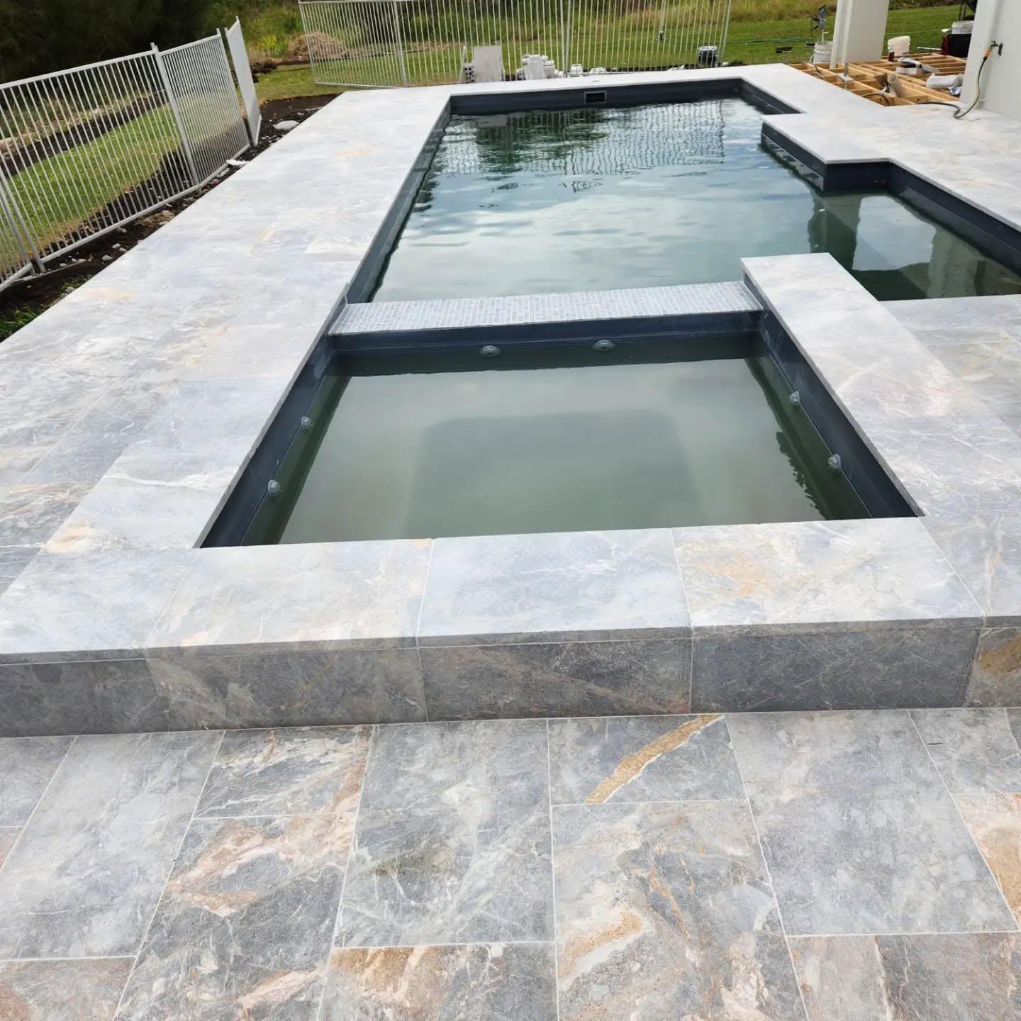 Fibonacci job in progress: stone-paved pool edge and plunge pool under construction