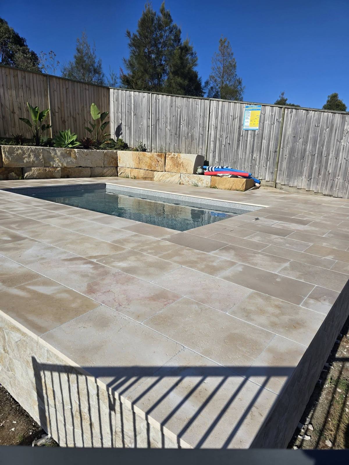 Sandstone retaining wall with garden bed planting